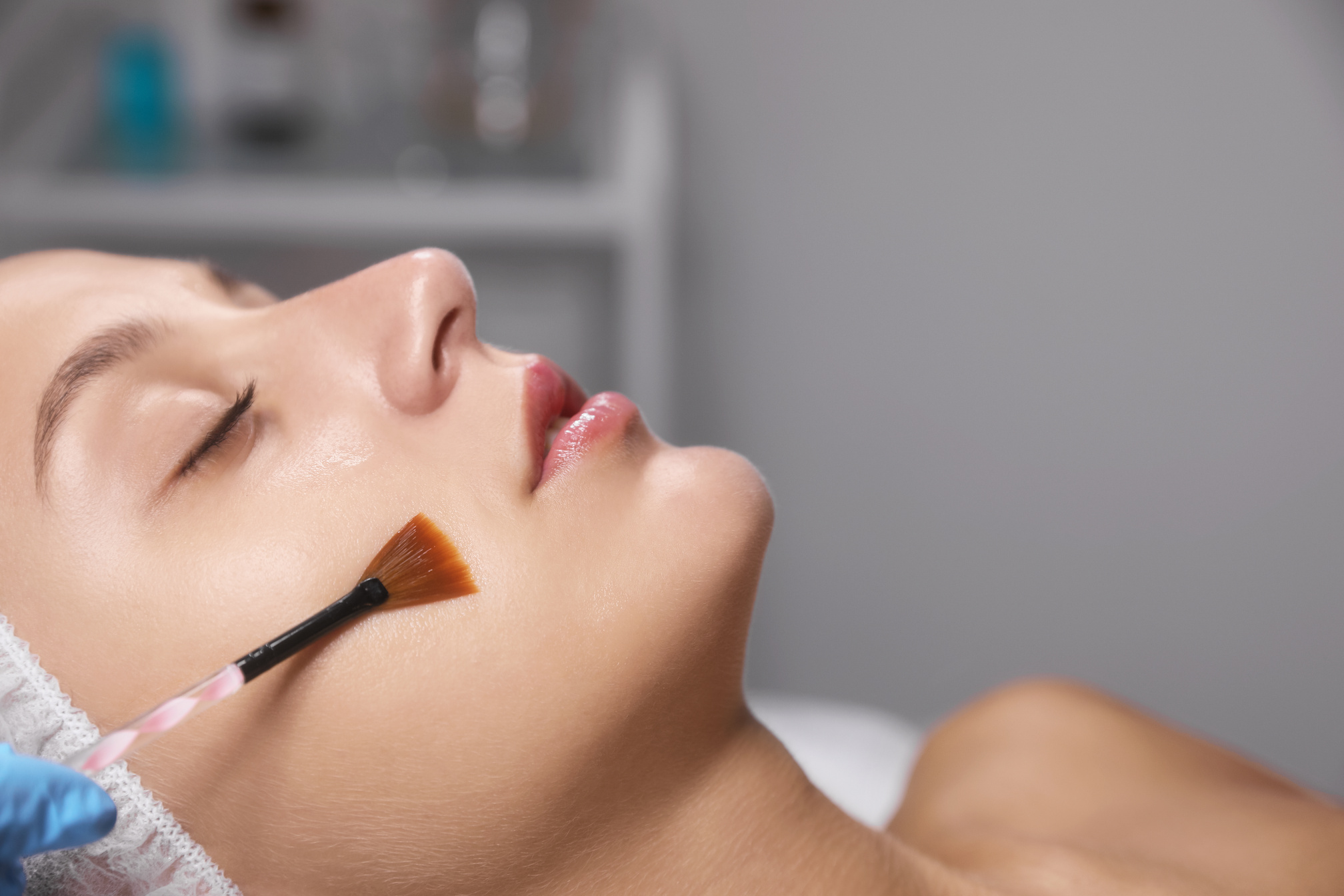 Cosmetologist Applying Chemical Peel Product on Client's Face in