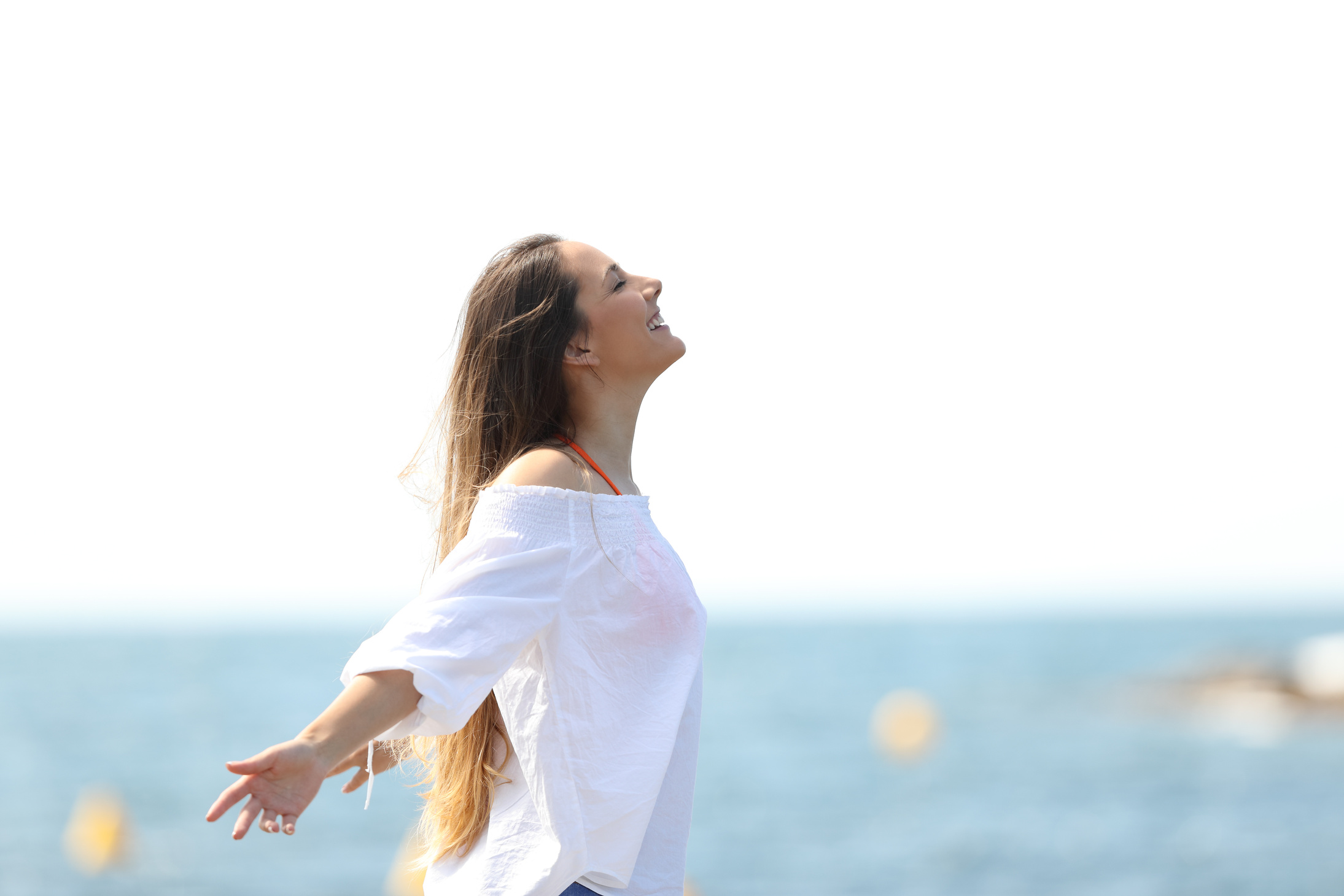 Relaxed woman breathing fresh air on the beach